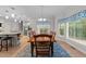 Bright dining room with large windows, a chandelier, and a view into the kitchen area at 5805 Laurel Rock Ln, Raleigh, NC 27613