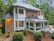 Exterior side view of a brick home featuring a sunroom and manicured landscaping at 5805 Laurel Rock Ln, Raleigh, NC 27613