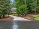 Secluded brick home with a long driveway nestled among mature trees, offering privacy and curb appeal at 5805 Laurel Rock Ln, Raleigh, NC 27613