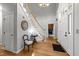 Bright and inviting foyer with hardwood floors, curved staircase, chandelier, and access to other rooms at 5805 Laurel Rock Ln, Raleigh, NC 27613