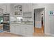 Kitchen features white cabinets and stainless steel appliances with an adjacent doorway at 5805 Laurel Rock Ln, Raleigh, NC 27613