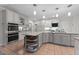 Spacious kitchen boasts white cabinets, stainless appliances, granite countertops, and convenient island at 5805 Laurel Rock Ln, Raleigh, NC 27613