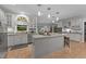 Kitchen boasts granite countertops, white cabinetry, pendant lighting, and stainless steel appliances at 5805 Laurel Rock Ln, Raleigh, NC 27613