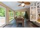 Sunroom with views, a dining table, a brick accent wall, and access to the outside at 5805 Laurel Rock Ln, Raleigh, NC 27613