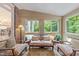 Bright sunroom with brick accent wall, vaulted ceiling, and views of the surrounding greenery at 5805 Laurel Rock Ln, Raleigh, NC 27613