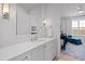 Bright bathroom with a white vanity, undermount sink, white countertops, and view of a Bedroom at 620 Wade Ave # 505, Raleigh, NC 27605