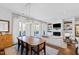 Elegant dining room with a wooden table, modern lighting, and access to the balcony at 620 Wade Ave # 505, Raleigh, NC 27605