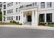 Stately white brick condo building entrance featuring columns and black framed windows at 620 Wade Ave # 505, Raleigh, NC 27605