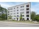 Striking white brick apartment building with multiple balconies and manicured landscaping at 620 Wade Ave # 505, Raleigh, NC 27605