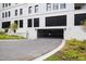 View of a secured, covered parking garage with lush landscaping surrounding at 620 Wade Ave # 505, Raleigh, NC 27605
