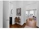 Welcoming hallway with hardwood floors leading to a bathroom and a living area at 620 Wade Ave # 505, Raleigh, NC 27605