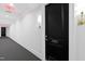 Well-lit hallway with dark doors, gold sconces, and neutral carpeting at 620 Wade Ave # 505, Raleigh, NC 27605