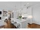 Open-concept kitchen with white cabinetry, marble counters, and island seating at 620 Wade Ave # 505, Raleigh, NC 27605
