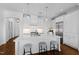 Modern white kitchen featuring a large island with seating and stainless steel appliances at 620 Wade Ave # 505, Raleigh, NC 27605