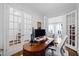 Home office with French doors, a modern desk, and an ergonomic chair at 620 Wade Ave # 505, Raleigh, NC 27605