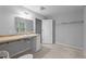 Bathroom featuring a large mirror, under-sink storage, and doorway leading to other room at 627 Gaslight Trl, Wendell, NC 27591