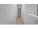 Hallway with neutral walls and modern lighting fixtures at 627 Gaslight Trl, Wendell, NC 27591
