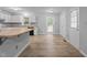 Bright eat-in kitchen featuring white cabinets, stainless appliances, and backyard access at 627 Gaslight Trl, Wendell, NC 27591