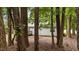 A view of the back of the home and its outdoor deck framed by trees at 627 Gaslight Trl, Wendell, NC 27591