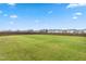 Large backyard with lush grass, enclosed by a wooden fence, offering ample space for recreation at 66 Arlie Ln, Lillington, NC 27546