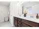 Bathroom with double sinks, dark cabinets and large mirror at 66 Arlie Ln, Lillington, NC 27546