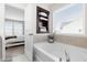 Bright bathroom featuring a soaking tub, window, and a view of the bedroom at 66 Arlie Ln, Lillington, NC 27546