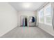 Bedroom with two clothing racks, neutral carpet, and a bright window at 66 Arlie Ln, Lillington, NC 27546