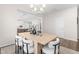 Cozy dining room featuring a modern chandelier, wood table, and views into other rooms, enhancing the open layout at 66 Arlie Ln, Lillington, NC 27546