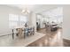 Bright dining area featuring a modern chandelier, wood table, and seamless transition to a well-equipped kitchen at 66 Arlie Ln, Lillington, NC 27546