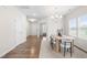 Bright dining room with hardwood floors, a modern chandelier, and natural light from large windows at 66 Arlie Ln, Lillington, NC 27546