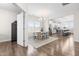Bright dining area featuring a modern chandelier, wood table, and seamless transition to a well-equipped kitchen at 66 Arlie Ln, Lillington, NC 27546