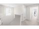Upstairs hallway with carpeted floors, natural light, and modern lighting fixture at 66 Arlie Ln, Lillington, NC 27546