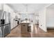 Open concept kitchen with stainless steel appliances, granite counters, large island, and hardwood floors at 66 Arlie Ln, Lillington, NC 27546