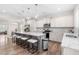 Gourmet kitchen featuring a center island with seating, granite countertops, and stainless steel appliances at 66 Arlie Ln, Lillington, NC 27546