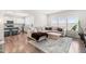 Bright and spacious living room with hardwood floors, a comfortable sofa, and an adjacent modern kitchen at 66 Arlie Ln, Lillington, NC 27546