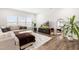 Cozy living room featuring a plush sectional sofa, large windows, and stylish decor for comfortable living at 66 Arlie Ln, Lillington, NC 27546