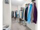 Spacious walk-in closet with carpet, shelving, and hanging rods for storage at 66 Arlie Ln, Lillington, NC 27546