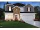 New home with two-car garage, dark shutters, brick and gray siding for a contemporary aesthetic at 667 White Birch Ln, Angier, NC 27501