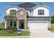 Charming two-story home with a brick facade, two-car garage, and well-manicured lawn at 667 White Birch Ln, Angier, NC 27501