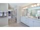 Bathroom with dual sinks, white cabinetry, and a view into the shower room at 673 Sun Meadow Dr, Wake Forest, NC 27587