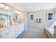 Bright bathroom with double vanity, soaking tub, and elegant fixtures at 673 Sun Meadow Dr, Wake Forest, NC 27587