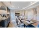 Bright dining room shows stairs, table set for meal, decorative cabinet, and modern decor at 673 Sun Meadow Dr, Wake Forest, NC 27587