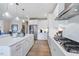 Bright white kitchen featuring stainless steel appliances, a spacious island and modern pendant lighting at 673 Sun Meadow Dr, Wake Forest, NC 27587