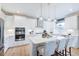 Bright kitchen with stainless steel appliances, white cabinets, island, and pendant lighting at 673 Sun Meadow Dr, Wake Forest, NC 27587