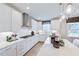 Bright kitchen features white cabinets, countertops, gas cooktop, and modern decor at 673 Sun Meadow Dr, Wake Forest, NC 27587