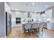 Bright kitchen with stainless steel appliances, white cabinets, island, and pendant lighting at 673 Sun Meadow Dr, Wake Forest, NC 27587