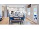 Eat-in kitchen boasts bright lighting, stainless appliances, a large island, and a dining area with a modern table at 673 Sun Meadow Dr, Wake Forest, NC 27587