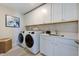 Clean laundry room with new washer and dryer, white cabinets, and a sink at 673 Sun Meadow Dr, Wake Forest, NC 27587