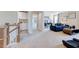 Open-concept living area with comfortable seating and a staircase at 673 Sun Meadow Dr, Wake Forest, NC 27587