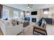 Bright living room features a fireplace, large windows, and comfortable seating at 673 Sun Meadow Dr, Wake Forest, NC 27587